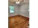 Charming bedroom with hardwood floors, beadboard, and natural light, perfect for relaxation and comfort at 490 S Moose Rd, Mount Pleasant, NC 28124