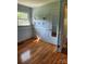 A bright bedroom showcases hardwood floors, paneled walls, and wall shelves above the chair rail at 490 S Moose Rd, Mount Pleasant, NC 28124