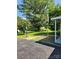 Scenic front yard featuring an American flag, lamp post and lush green space with mature trees under a clear sky at 490 S Moose Rd, Mount Pleasant, NC 28124