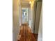 A hallway features hardwood floors and access to other rooms, offering a view of the home's layout at 490 S Moose Rd, Mount Pleasant, NC 28124