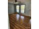 Inviting living room featuring original hardwood floors, two windows and a door to the exterior at 490 S Moose Rd, Mount Pleasant, NC 28124
