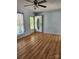 Bright living room showcasing original hardwood floors, a white front door, and natural light at 490 S Moose Rd, Mount Pleasant, NC 28124
