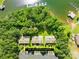 Stunning aerial view of townhomes, lake access, and boat docks surrounded by lush greenery at 49009 Dockside Ln # D, Albemarle, NC 28001