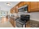 Functional kitchen equipped with stainless steel appliances, wood cabinetry, and ample counter space at 49009 Dockside Ln # D, Albemarle, NC 28001
