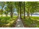 Scenic wooded pathway leading to the waterfront, creating a tranquil and picturesque setting at 49009 Dockside Ln # D, Albemarle, NC 28001