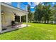 Spacious patio with seating area and a view of the lush green backyard and lake at 49009 Dockside Ln # D, Albemarle, NC 28001