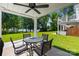 Covered patio with outdoor seating and a picturesque view of the lawn and lake at 49009 Dockside Ln # D, Albemarle, NC 28001