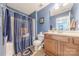 Cozy bathroom featuring a shower with themed curtain, a toilet, and a vanity with cabinets, providing a functional space at 516 Fair Oaks Dr, Fort Mill, SC 29708