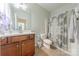 Cozy bathroom with wooden vanity, mirror, and shower with decorative curtain at 516 Fair Oaks Dr, Fort Mill, SC 29708