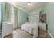 Bedroom with built-in desk, shelving, and mint green walls at 516 Fair Oaks Dr, Fort Mill, SC 29708