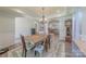 Open dining room showcases tray ceilings, wood floors, and views into the kitchen at 516 Fair Oaks Dr, Fort Mill, SC 29708