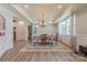 Spacious dining room with a tray ceiling, chandelier, and large windows for natural light at 516 Fair Oaks Dr, Fort Mill, SC 29708
