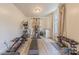 Home gym features a variety of exercise equipment and natural light from a window with neutral curtains at 516 Fair Oaks Dr, Fort Mill, SC 29708
