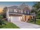 Charming two-story home featuring stone and siding, a two-car garage, and manicured landscaping at 516 Fair Oaks Dr, Fort Mill, SC 29708