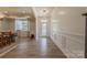 Bright foyer featuring wood floors, white wainscoting, and a decorative glass front door at 516 Fair Oaks Dr, Fort Mill, SC 29708