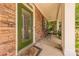 Inviting front porch with stone accents, green front door, seating area, and manicured landscaping at 516 Fair Oaks Dr, Fort Mill, SC 29708