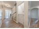Bright hallway with wood floors, archways, and a charming Dutch door leading to storage at 516 Fair Oaks Dr, Fort Mill, SC 29708
