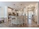 Open kitchen with bar seating, stainless appliances and light wood flooring at 516 Fair Oaks Dr, Fort Mill, SC 29708