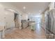 Open-concept kitchen featuring stainless steel appliances, a center island, and white cabinets at 516 Fair Oaks Dr, Fort Mill, SC 29708