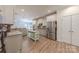 Well-lit kitchen boasts granite countertops, stainless appliances, light wood floors, and a central island at 516 Fair Oaks Dr, Fort Mill, SC 29708