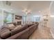 Open-concept living room with fireplace, ceiling fan, and seamless flow into the kitchen at 516 Fair Oaks Dr, Fort Mill, SC 29708