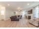 Spacious living room featuring a large sectional sofa, fireplace, and light wood flooring at 516 Fair Oaks Dr, Fort Mill, SC 29708