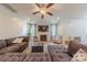 Large living room features a sectional sofa, ceiling fan, fireplace, tv and light wood flooring at 516 Fair Oaks Dr, Fort Mill, SC 29708
