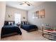 Inviting bedroom with two beds, soft carpet, picture window and wall art at 5440 Kinsbridge Dr, Charlotte, NC 28227