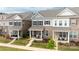 Desirable townhomes with covered front porches, colorful flower beds, and lush green lawns at 5440 Kinsbridge Dr, Charlotte, NC 28227