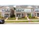 Charming townhome boasts a well-manicured lawn, flowering shrubbery, and covered front porch at 5440 Kinsbridge Dr, Charlotte, NC 28227