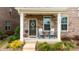 Inviting covered front porch with rocking chairs and decorative wreath for relaxed outdoor living at 5440 Kinsbridge Dr, Charlotte, NC 28227