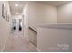 Upstairs hallway with neutral carpeting and white trim at 5440 Kinsbridge Dr, Charlotte, NC 28227