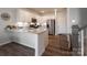 Charming kitchen featuring granite countertops, white cabinetry, stainless appliances, and wood floors at 5440 Kinsbridge Dr, Charlotte, NC 28227