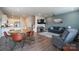 Open-concept living area with wood floors, modern furnishings, and seamless flow to dining and kitchen at 5440 Kinsbridge Dr, Charlotte, NC 28227
