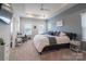 Spacious main bedroom with tray ceiling, lots of light, and an attached desk area at 5440 Kinsbridge Dr, Charlotte, NC 28227