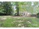 Large backyard featuring lush mossy grass and a charming single-story home, creating a serene outdoor space at 6128 Coatbridge Ln, Charlotte, NC 28212