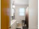 Well-lit bathroom featuring a vanity, updated fixtures and a window bringing natural light at 6128 Coatbridge Ln, Charlotte, NC 28212