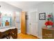 A bedroom featuring a desk, chair, a doorway to the bathroom, and a closet door at 6128 Coatbridge Ln, Charlotte, NC 28212