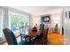 Bright dining room with a large window, hardwood floors, and stylish decor at 6128 Coatbridge Ln, Charlotte, NC 28212