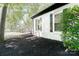 Charming exterior of home featuring manicured black mulch beds and white painted brick at 6128 Coatbridge Ln, Charlotte, NC 28212