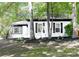 Charming house with lush greenery, featuring black shutters, a stone bench, and meticulously maintained landscaping at 6128 Coatbridge Ln, Charlotte, NC 28212