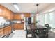 Well-appointed kitchen with wooden cabinetry, stainless steel appliances, and a dining area at 6128 Coatbridge Ln, Charlotte, NC 28212