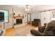Inviting living room with a fireplace, ceiling fan, barn door, and comfortable seating on hardwood floors at 6128 Coatbridge Ln, Charlotte, NC 28212