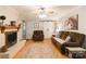 Relaxing living room featuring a fireplace, ceiling fan, hardwood floors, and sliding barn door at 6128 Coatbridge Ln, Charlotte, NC 28212