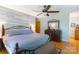 A main bedroom featuring a wood accent wall, a bed, a dresser, and an overhead ceiling fan at 6128 Coatbridge Ln, Charlotte, NC 28212