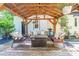 Outdoor patio features a wooden pergola and comfortable seating around a wooden coffee table at 6128 Coatbridge Ln, Charlotte, NC 28212