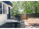 Beautifully landscaped side yard with a small tree, wooden fence, and access to the front entrance at 6128 Coatbridge Ln, Charlotte, NC 28212