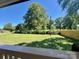 Spacious backyard with a mix of green grass, large trees, and a newly installed wood fence at 614 E Main Ave, Taylorsville, NC 28681