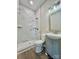 Bathroom featuring a stand up shower with marble-style tiling and vanity sink at 614 E Main Ave, Taylorsville, NC 28681