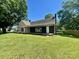 Charming single-story home with a covered porch, chimney, and well-maintained lawn under a clear blue sky at 614 E Main Ave, Taylorsville, NC 28681